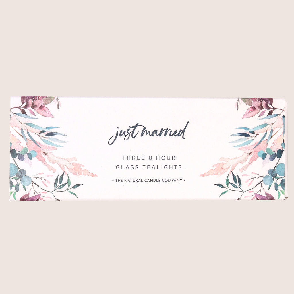 Three glass tealights in a pink and blue leafy sleeve with 'just married' text